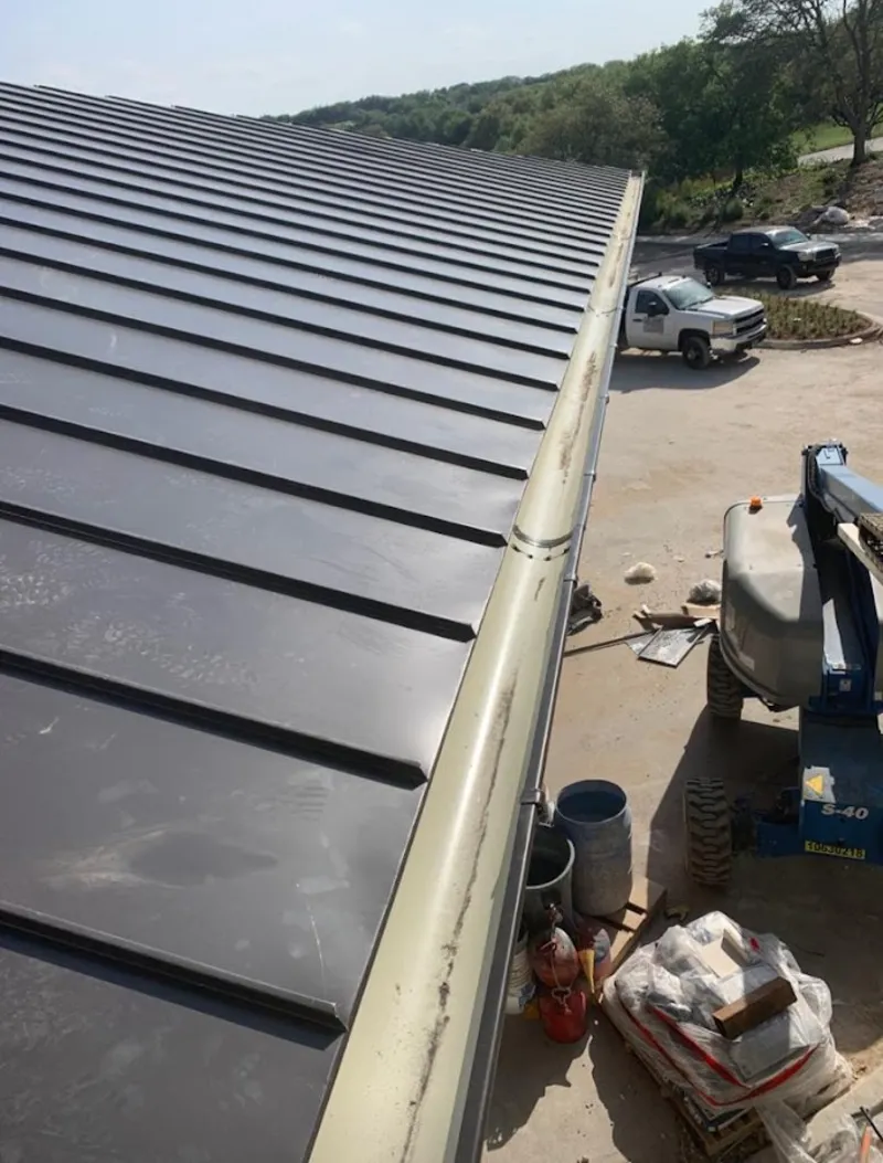 Standing seam panel and gutter detail on a metal roofing jobsite in Gunbarrel